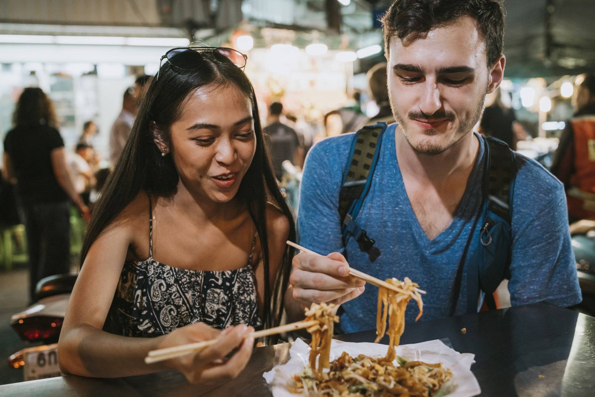 Young couple having dinner together at the night market