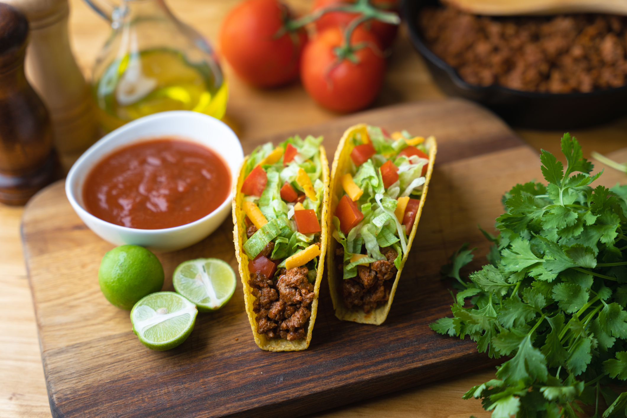 hard shell taco on wooden board with lime