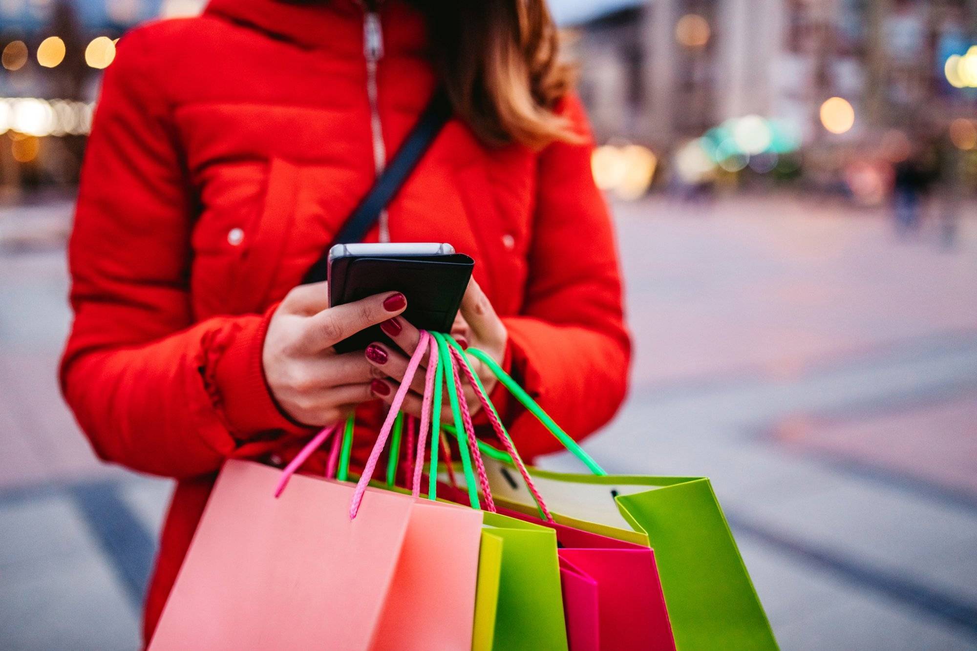 Woman with shopping bags using phone