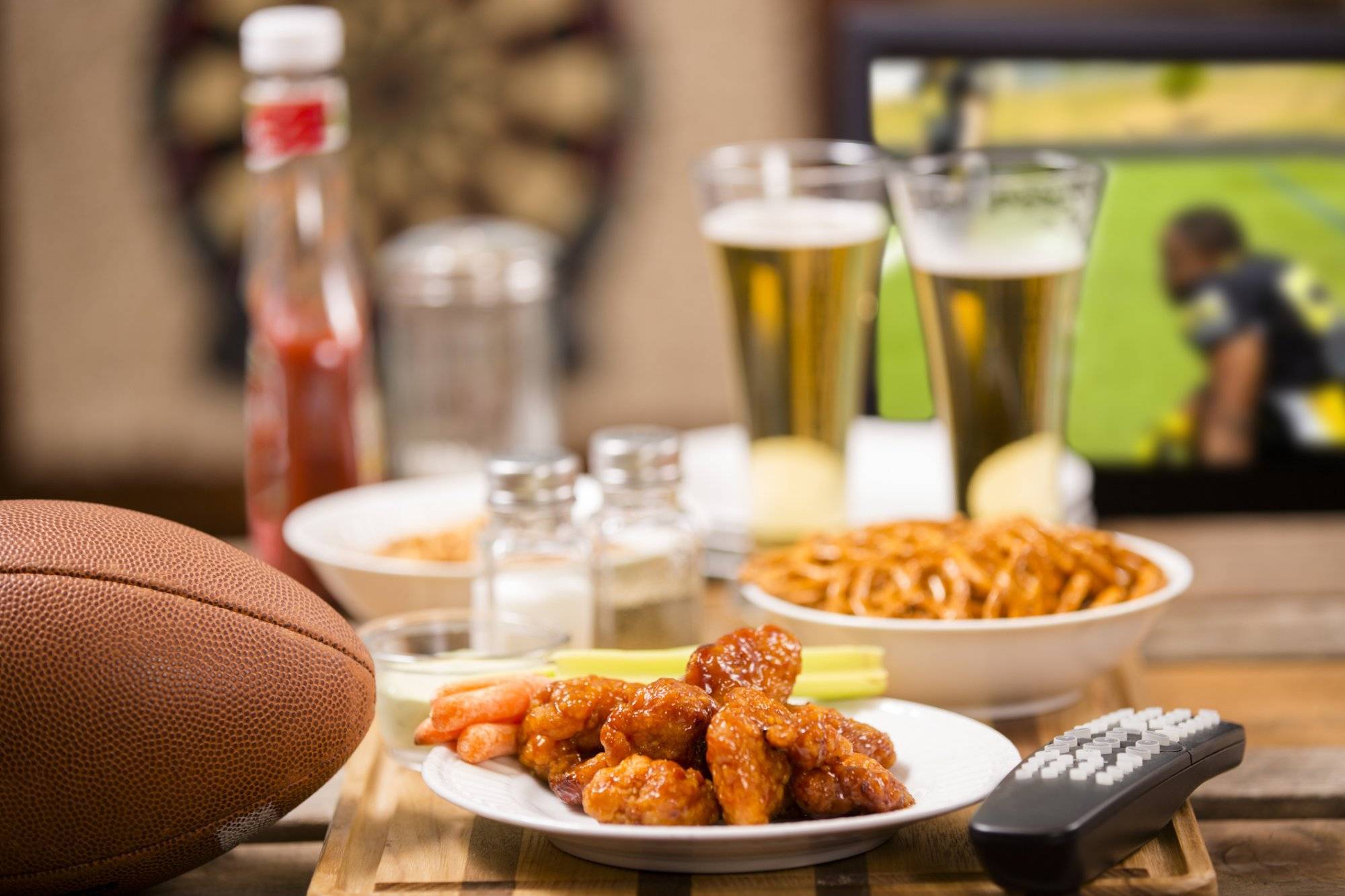 Watching football game on television at local pub. Food, beer. Watching football game on television at local pub. Food, beer.