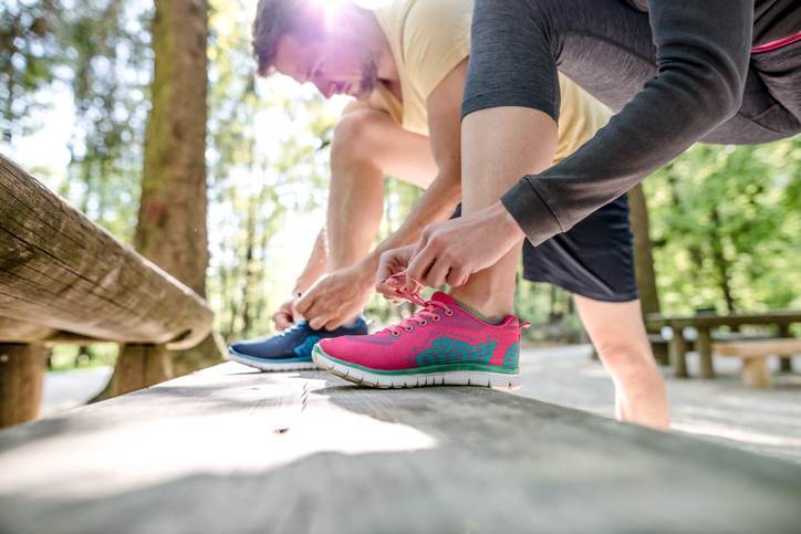 Couple tying shoes