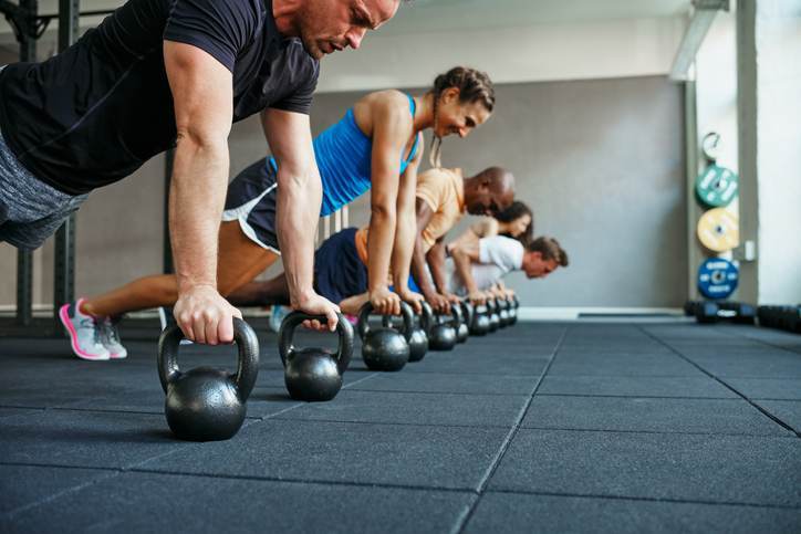 People doing pushups together in a health club class